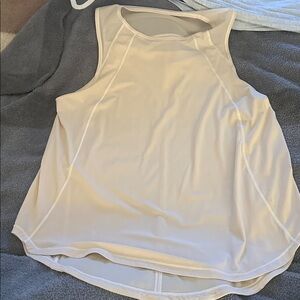 Light cream  Lululemon tank. Size Large, 21 ptp. Little spots shown in pics